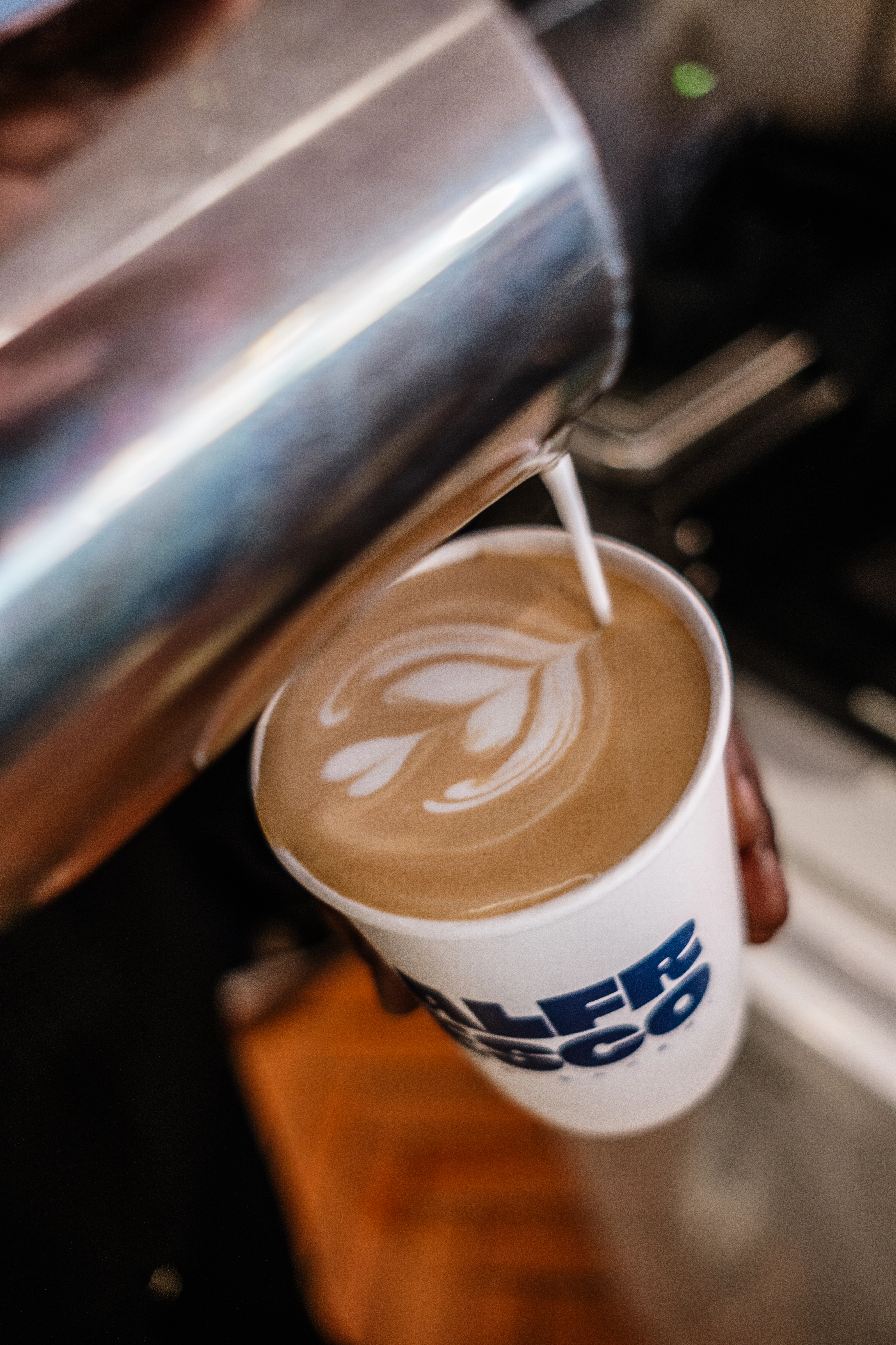 Aesthetic latte art with heart-shaped milk pour in coffee cup at Alfresco