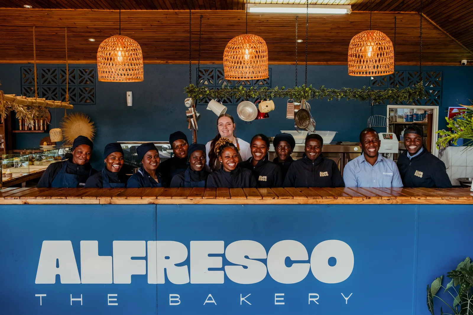 Alfresco Bulawayo branch team smiling behind the bakery counter