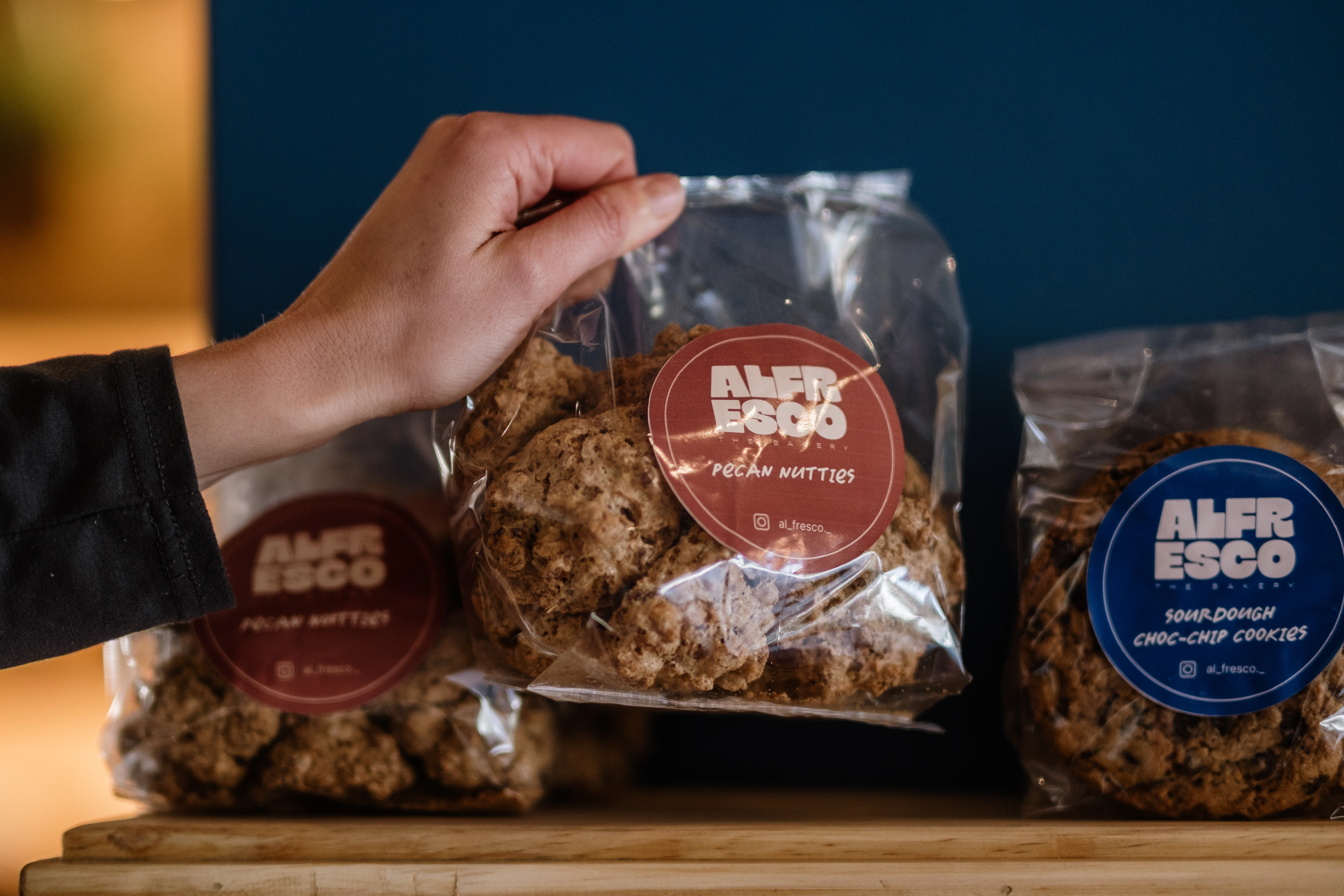 Alfresco pecan nutties being held in hand with aesthetic styling
