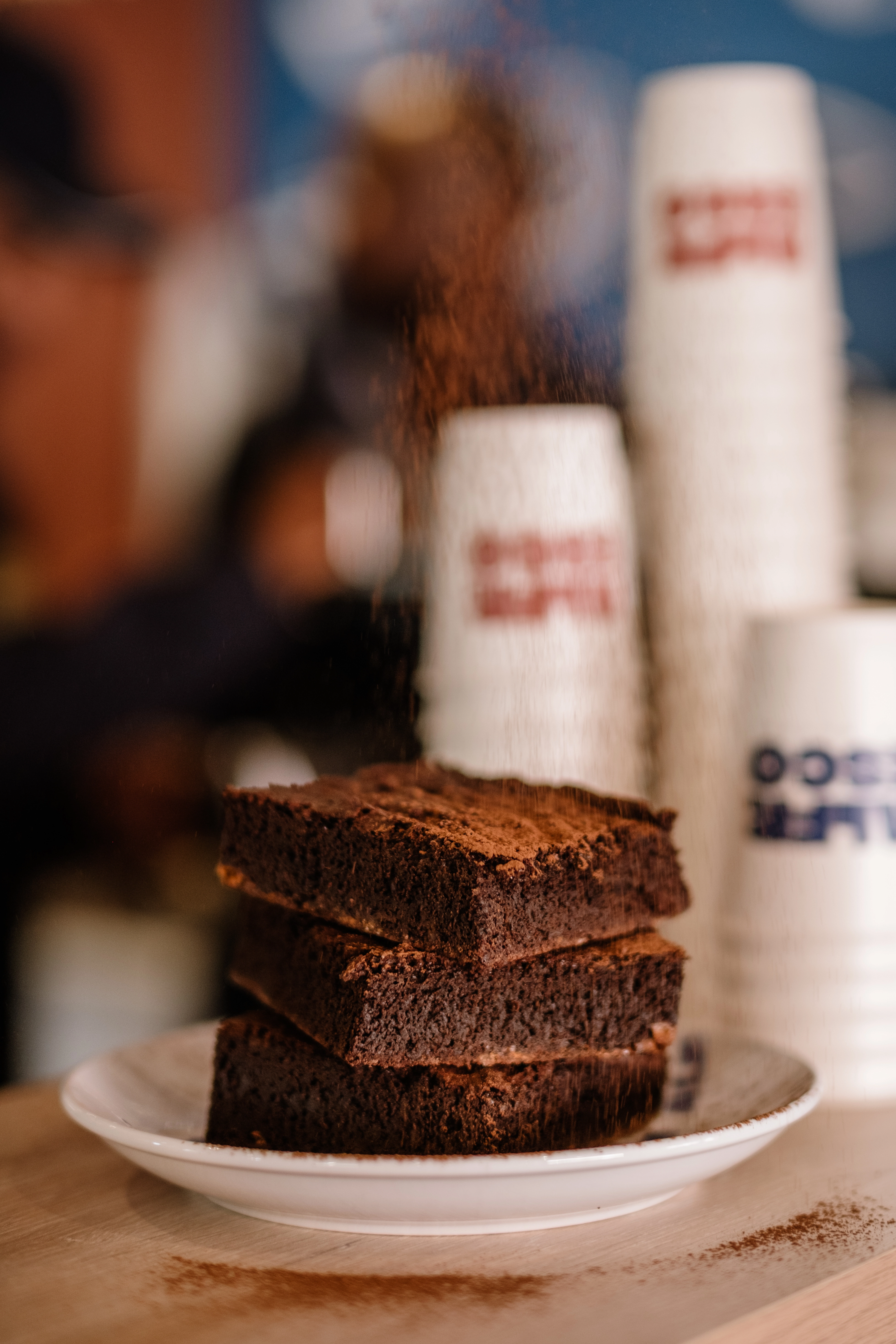 Cakes being dusted with powdered sugar