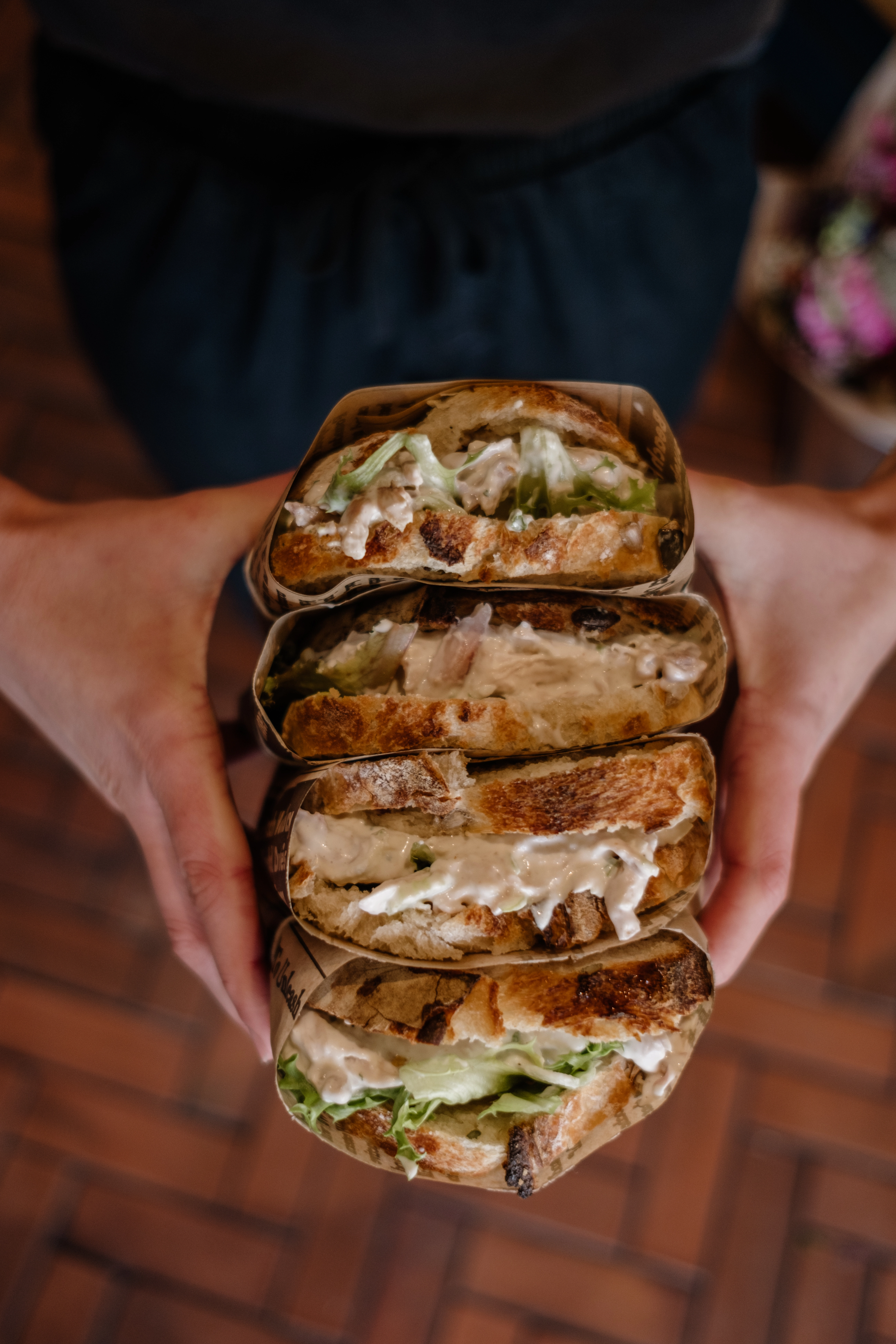 Chicken mayo sandwiches being held in hand